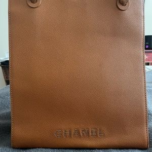 Chanel Bag. 2 deep pockets inside. Burnt orange /brown color. Authenticity card.
